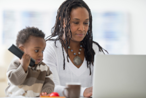 working woman with her child next to the computer