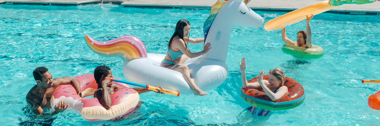 teens in pool on floats enjoying summer