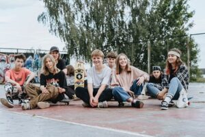 teens sitting outside at skate park