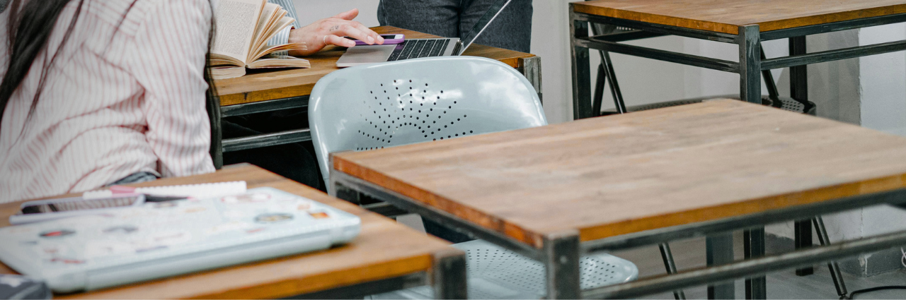 empty seat among students desks within a classroom