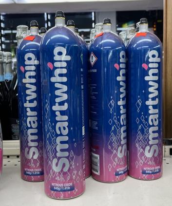 bottles of Smartwhip (nitrous oxide) on a convenience store shelf